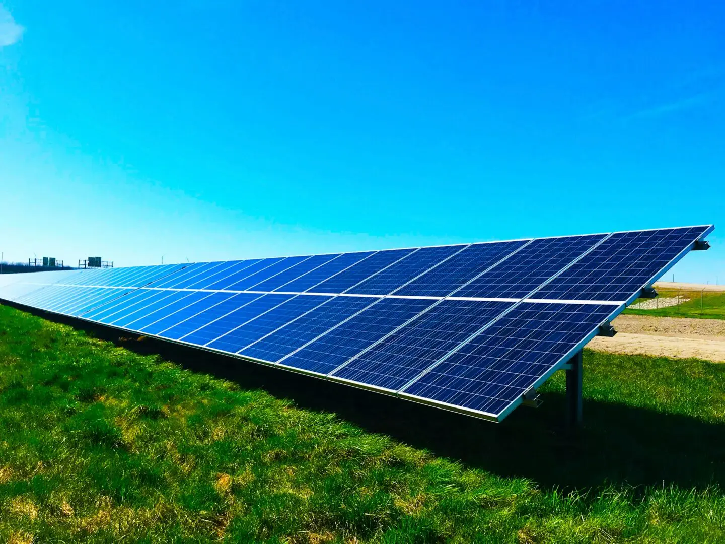 A large solar panel sitting in the middle of a field.